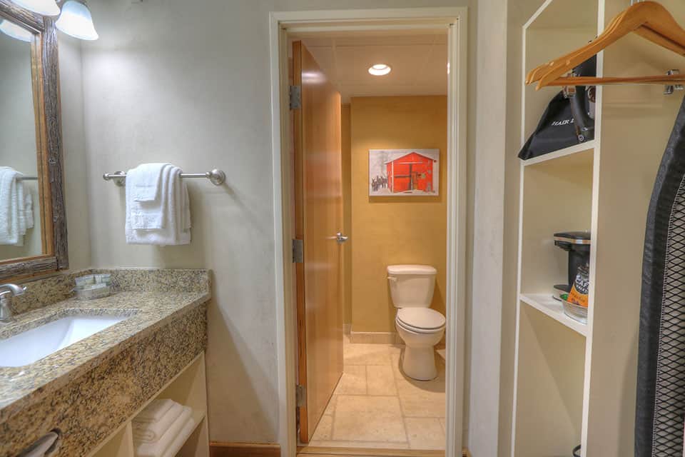 Spacious bathroom with granite vanity in hotel room