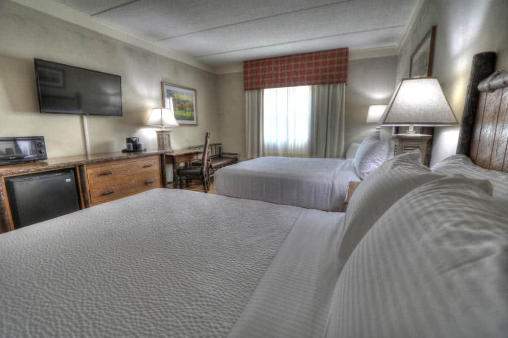 Two queen beds in room at The Lodge at Five Oaks hotel in Sevierville