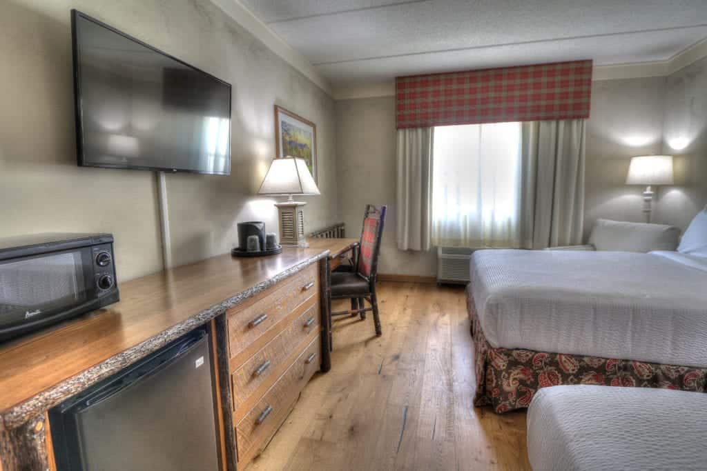 Rustic decor in hotel room with two queen beds at The Lodge at Five Oaks