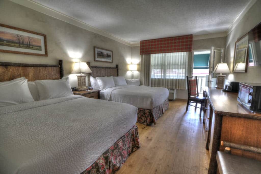 deluxe room with two queen beds and balcony at hotel in Sevierville Tn