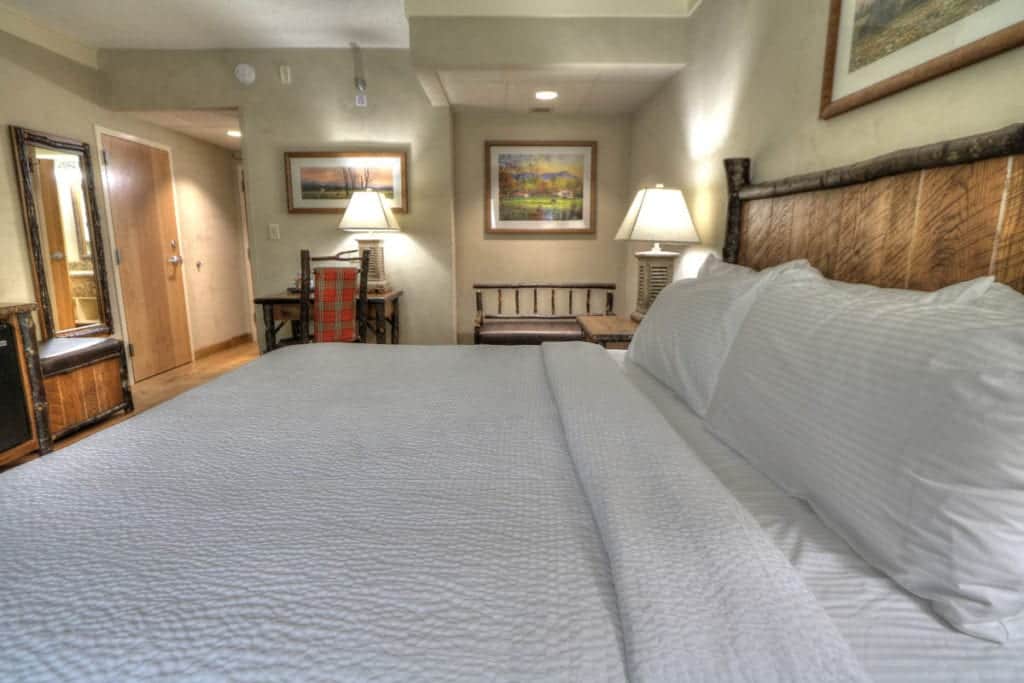 Luxurious linens on king bed in room at The Lodge at Five Oaks hotel in Sevierville Tn