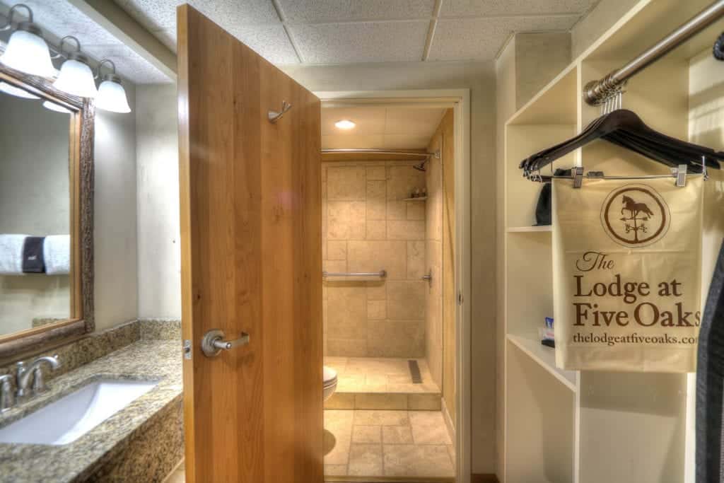 Tile shower in premier king room at The Lodge at Five Oaks