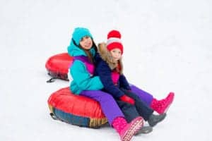 sisters snow tubing together